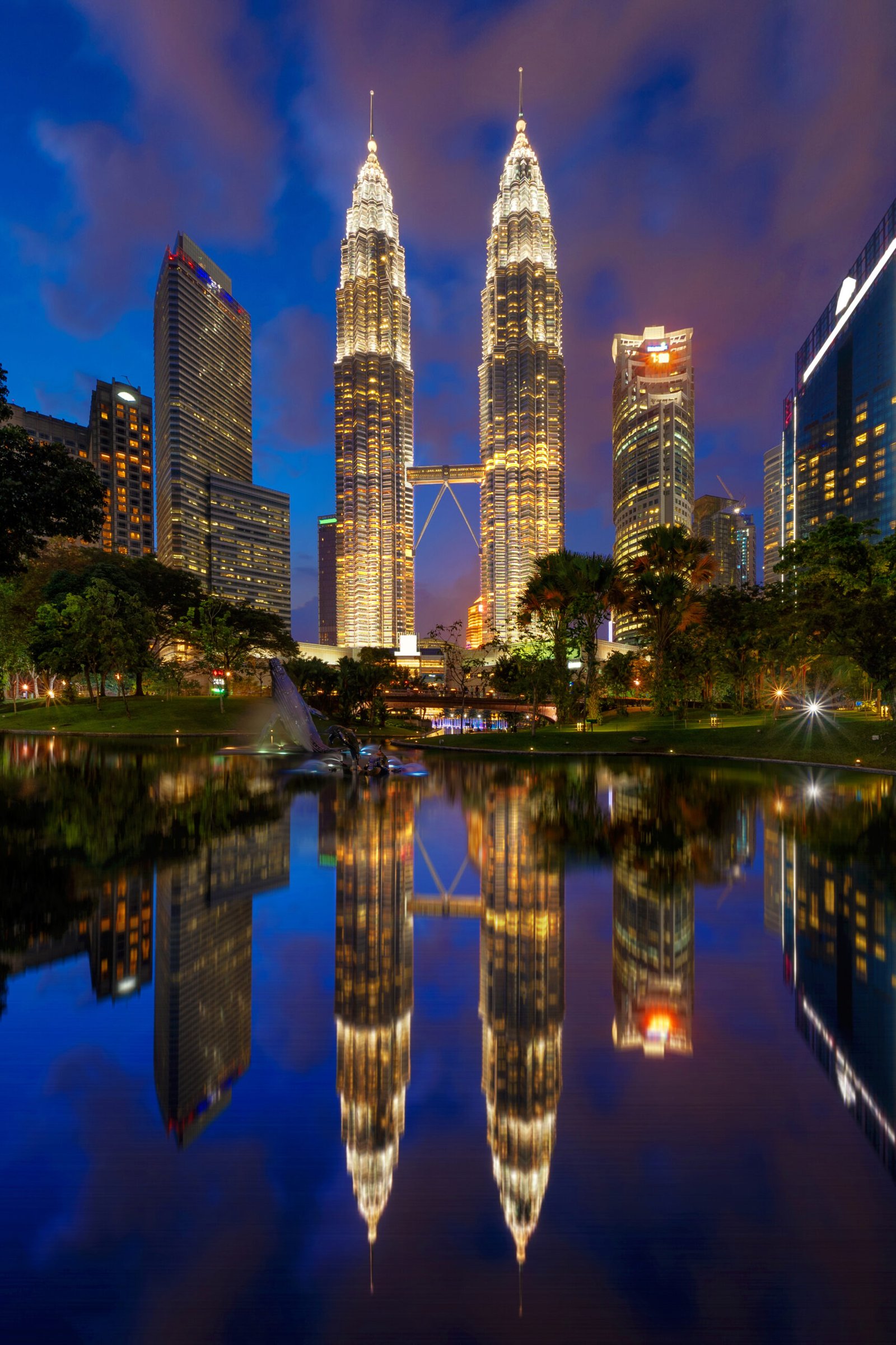 Petronas Twin Towers in Kuala Lumpur Downtown with reflection, Malaysia. Financial district and business centers in smart urban city in Asia. Skyscraper and high-rise buildings at night.